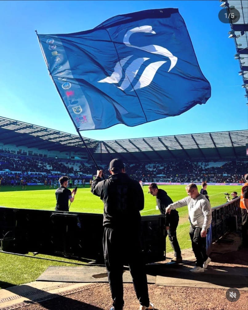 Swans Flag Crew waving the flag at the Swansea.com Stadium